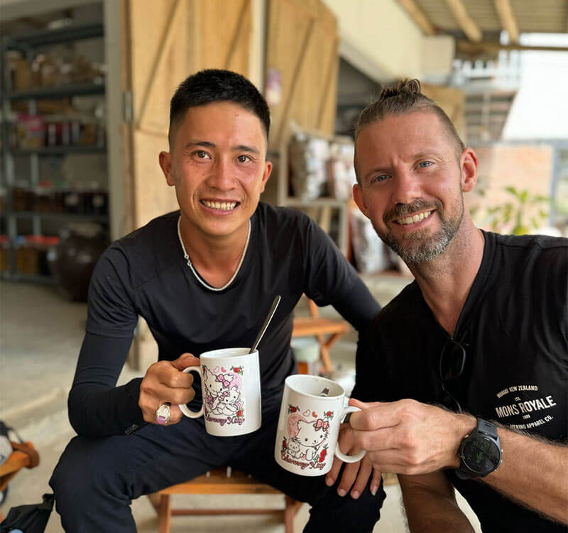 Adam Donovan having coffee with a local friend on tour in Vietnam.