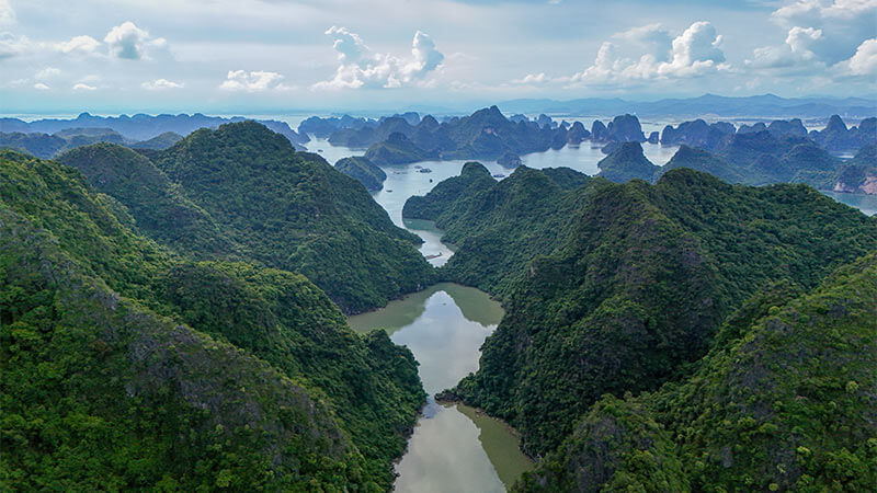 Aerial view of a ha long bay surrounded by mountains in Vietnam.